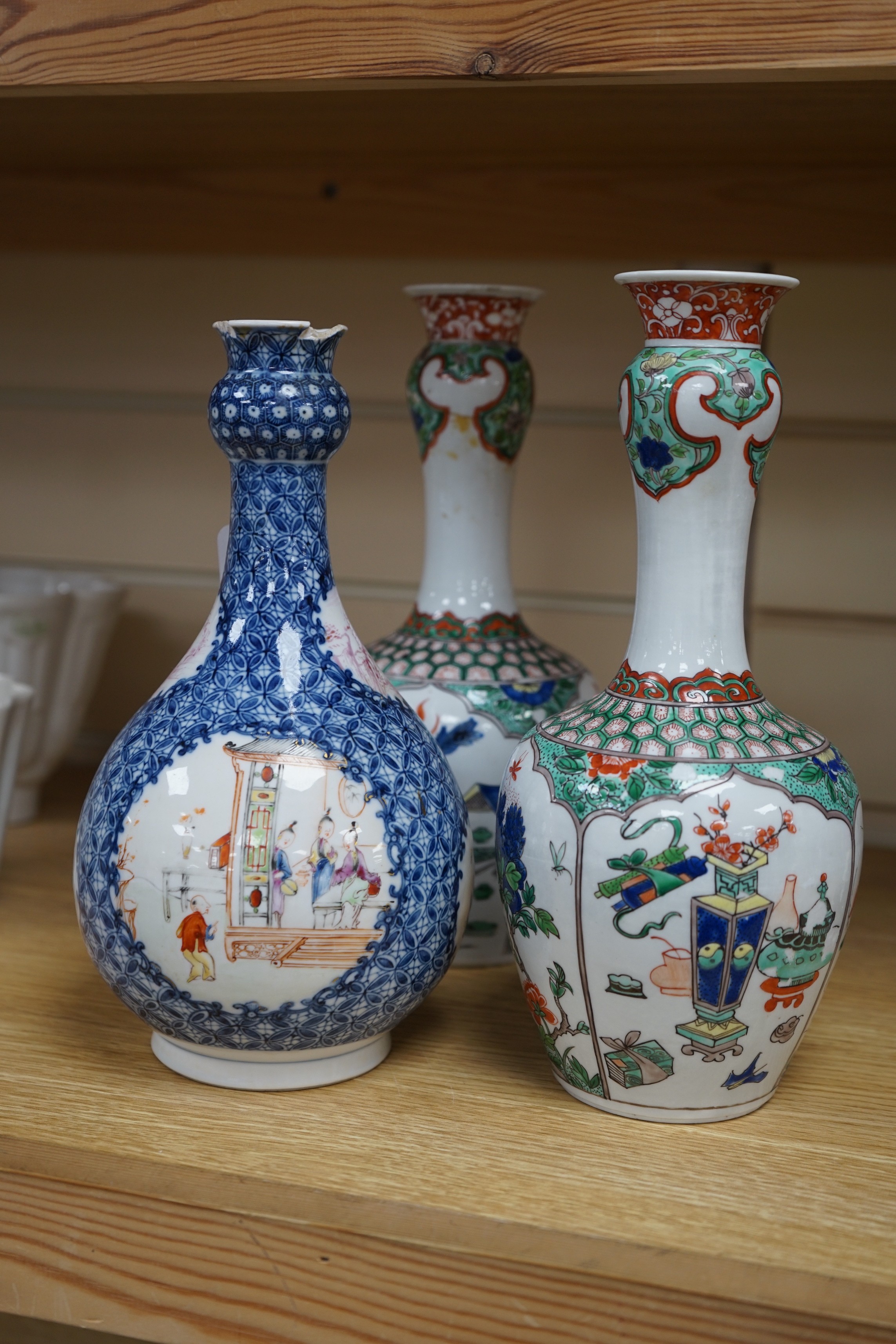 A pair Samson of Paris vases in the Chinese famille verte style and a Chinese Qianlong famille rose garlic neck vase with blue panelling motif, tallest 26cm